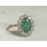 A 9ct gold emerald and diamond ring , 2.3G . Size