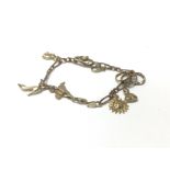 A 9ct gold charm bracelet. Approx 14.26 grams.