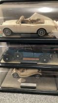 A Collection of Franklin Mint Cars In Display Case