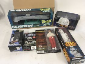 An assortment of 6 boxed items, including action f