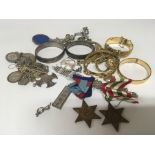 A collection of silver jewellery bangles a charm b