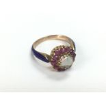 An 18ct gold ring set with a central opal surround