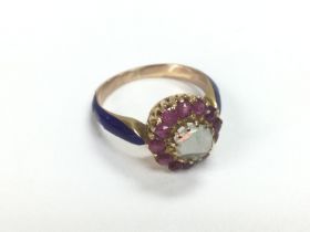 An 18ct gold ring set with a central opal surround