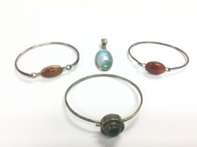 Three silver stone set bracelets and a silver ston