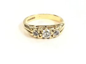 An 18ct gold 3 diamond stone ring. Size L and 4.4g