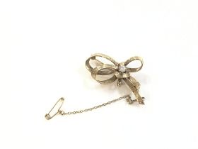9ct gold bow brooch set with white stone. 5.7g Pos