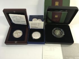 Three silver coins including a proof Swiss Army kn