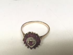 A 9carat gold ring set with a pattern of ruby and