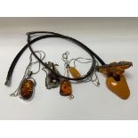 A small collection of silver amber and mixed costu