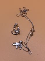 An 18ct white gold and diamond elephant pendant wi