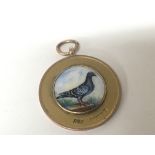 A 9carat gold pigeon racing medal with enamel deco