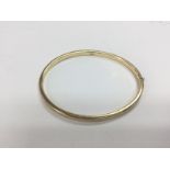 A 9ct gold oval bangle. Approx 5g. Shipping catego