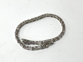 A 9ct white gold and CZ set line bracelet, 11.7g (