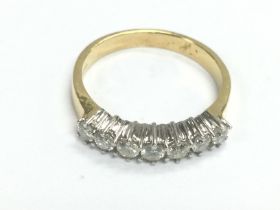 An 18ct gold seven stone diamond ring, approx 0.50ct, approx 3.7g and approx size N. Shipping