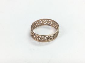 A yellow metal ring stamped 585 with piercework de