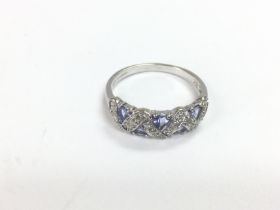 A 9ct white gold ring set with five brilliant cut