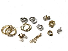 11 pairs of gold and stone set earrings. (A)