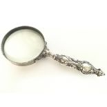 Victorian magnifying glass with ornate silver hand