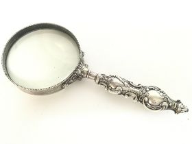 Victorian magnifying glass with ornate silver hand