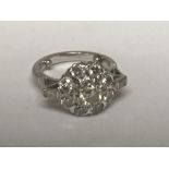 An 18carat white gold ring set with a cluster of b