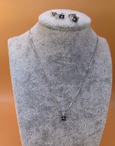 A 9ct white gold sapphire and diamond pendant with