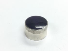 A silver and enamel pill box, approx width 3cm. Sh