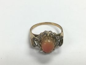 An unusual 9ct gold, pink coral and diamond ring,