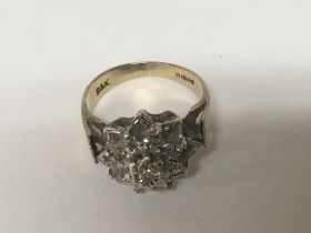 A 9carat gold ring set with a cluster of chip ston