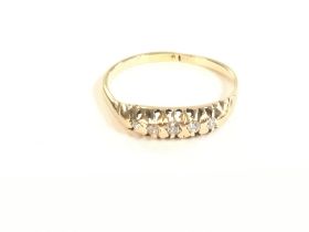 An 18 ct gold diamond 5 stone ring. 2.1g and size