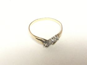 A 9carat gold ring set with a row of four small di