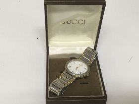 A Gucci midi stainless steel and gold plated quart
