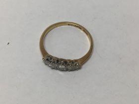 An 18ct gold ring set with graduated old cut diamo