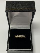 An 18ct gold and 5 stone diamond ring. (A).