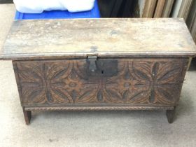 A small chest with a carved symmetrical pattern de