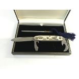 A silver pocket knife with sharpening rod. Postage