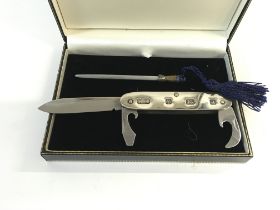 A silver pocket knife with sharpening rod. Postage