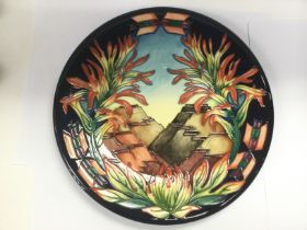 A boxed Moorcroft circular wall plaque depicting s