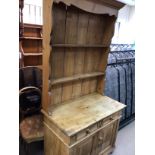 A pine dresser the raised back above two drawers a