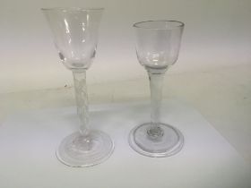 Two 18th Century wine glasses one with an air twis