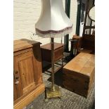 An Antique brass lamp base in the form of a Corint