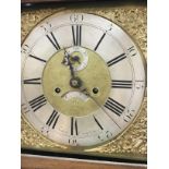 A oak eight day long case clock the brass dial wit