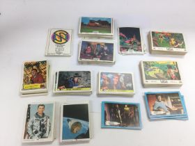 A collection of collector's cards including Captain Scarlet, Star Trek, Tarzan, Land Of The