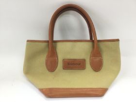 A small Barbour bag, approx width 31cm. Shipping c
