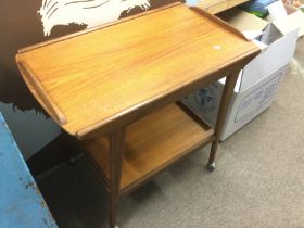 A mid 20th Century teak tea trolley. Shipping cate