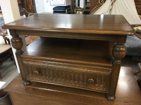 An Ercol side table the top with a twin flap top a