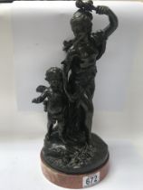 A bronze figure group in classical form depicting maiden and cherub, on a marble base. 35cm in