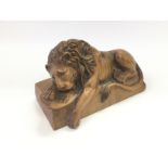 A carved wooden lion, approx length 18cm. Shipping