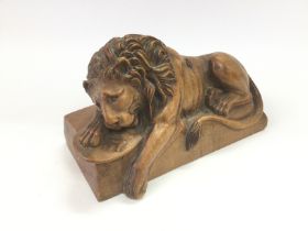 A carved wooden lion, approx length 18cm. Shipping