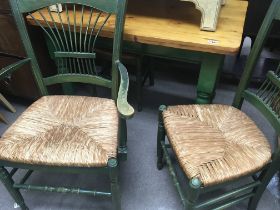 A green painted pine kitchen table with three gree