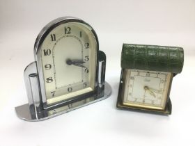 An Art Deco style chrome clock and a folding trave